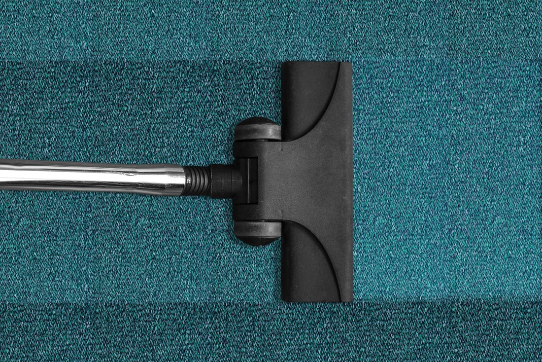 Vacuuming up a dirty carpet to make it look brand new.